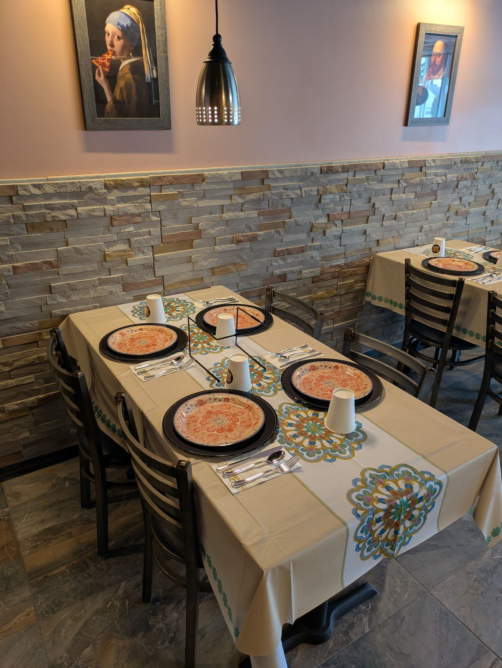Dining tables and pizza-portrait artwork
